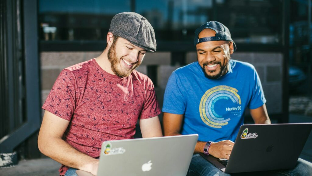 man in blue crew neck t-shirt using macbook